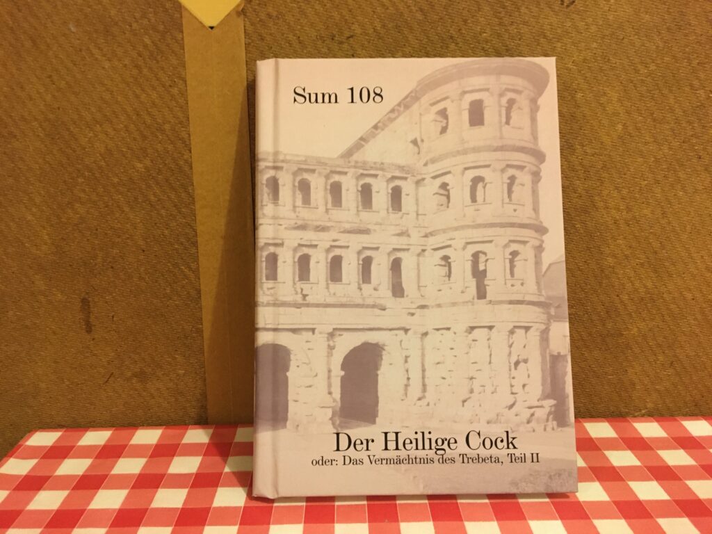 Bild des Buchs "Der Heilige Cock oder: Das Vermächtnis des Trebeta Teil II" auf dem Küchentisch des Autors